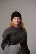 © Юрий Горид - young girl model in black cap and grey jackett isolated on grey background. Product photo mockup for fashion brands and marketplaces.