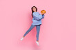 © deagreez - Full body photo of young pretty woman buy pumpkin grocery organic jump isolated over pink color background