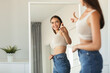 © Prostock-studio - Pretty Female Pointing Finger At Her Reflection In Mirror Indoors