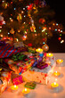 Christmas and New Year composition: burning candles and gift boxes under the Christmas tree, vertical
