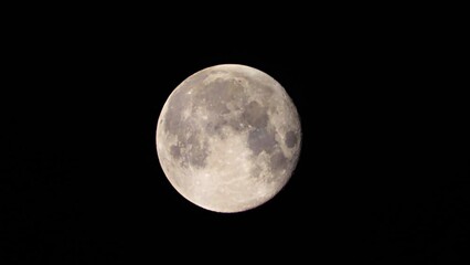 Wall Mural - Full Moon close-up against a black sky. Dark clouds are flying in front of the Moon