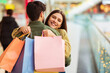 © Prostock-studio - Female Buyer Hugging Husband Holding Bags Shopping In Mall Indoors