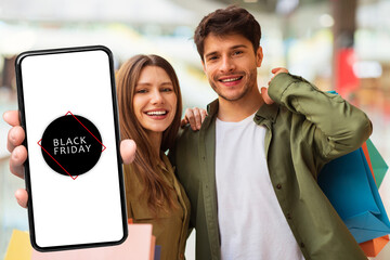Poster - Couple Showing Smartphone Advertising Black Friday Offer In Modern Mall