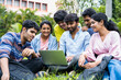 © WESTOCK - group of young students checking exam results or waiting for project approval on laptop at collage campus - concept of teamwork, bonding and friendship.