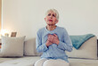 © Jelena Stanojkovic - Senior adult elderly women sit on bed with chest pain suffering from heart attack in the bedroom.Healthcare and medical concept.