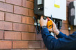 © Austockphoto - Electrician trady with multimeter tool doing solar power system installation