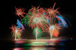 © Austockphoto - Multi coloured fireworks exploding over an ocean in the night sky.