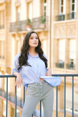 Wall Mural - Fashion portrait of beautiful young woman, wearing blue shirt, posing outdoors