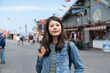 © PR Image Factory - portrait of smiling asian chinese woman tourist enjoying view while visiting Old Fishermanâs Wharf in California usa with colorful shop background