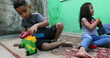 © Marco - Brazilian children playing outside in backyard toys, hispanic south american people