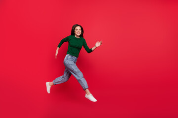 Sticker - Full length photo of active excited lady run fast rush shopping wear trendy green long sleeve shirt isolated on bright red color background