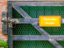 Please Close The Gate Sign On Rusty Metal Gate