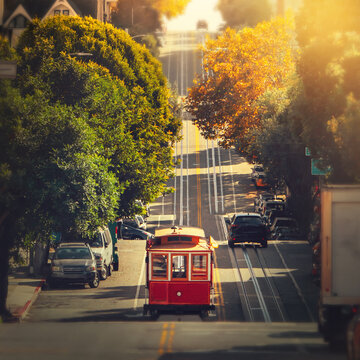 Fototapete - Traditional  retro cable tram riding on famous street in the middle of day in October, San Francisco, California, USA