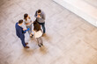 © BGStock72 - Aerial view at business people team discussing in the office hallway