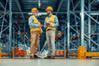© ivanko80 - Managers in warehouse discuss about business
