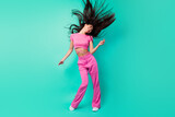 Full size image of rejoiced laughing girl feel free dancing in nightclub flying hair isolated on teal color background