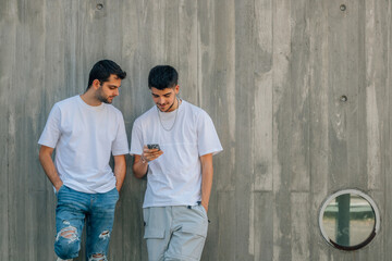 Poster - two young friends on the street with mobile phone