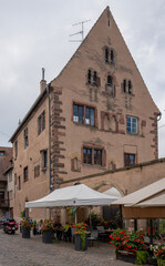 Wall Mural - Obernai, France - 09 13 2019: View of an old Roman Alsatian house facade in the village