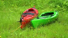 Green And Red Kayak On Green Grass