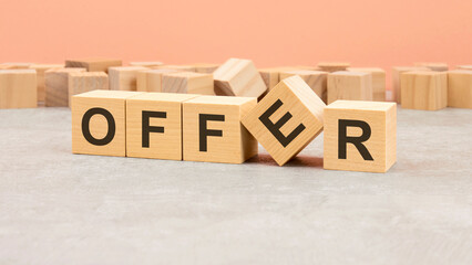 Sticker - word offer on wooden cubes and wooden background