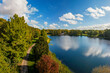canvas print picture - Herbstliche Stimmung im Speckenbütteler Park in Bremerhaven, Panorama Aussicht aus der Luft, prächtige Farben am Bootsteich, Wolken am Himmel, Blauer Himmel über den Bäumen, Aerial landscape view 
