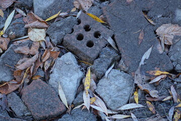 Sticker - stone texture of pieces of brown bricks and gray stones in the old sidewalk on the street