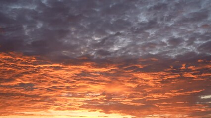 Wall Mural - early morning scenic dramatic cloudscape with colourful orange and purple clouds. 4k video time laps