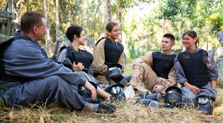 Canvas Print - Team of paintball players discussing the past game