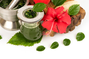 Hair care with red hibiscus flowers and green leaves isolated on white background.