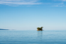 Small Rocky Island Lies In Completely Calm Lake Champlain Near Vermont