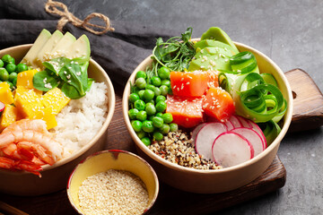 Wall Mural - Poke bowls with shrimps, salmon, avocado and mango