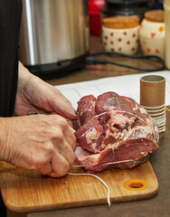 Sticker - Chef ties the beef with rope and prepares it for baking in the oven