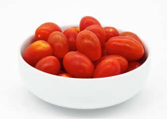 Wall Mural - Red cherry tomatoes in a bowl isolated on white background.