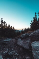 Sticker - Beautiful vertical aerial view of a sunset over mountains up in the hills with blue sky background