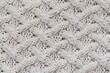 Knit cashmere beige wool. Natural woolen fabric, sweater fragment.