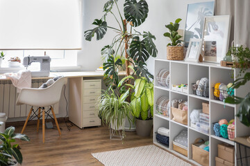 Wall Mural - Modern workplace of tailor textile craft designer table with sewing machine and laptop near window