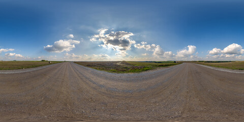 Wall Mural - full seamless spherical hdri 360 panorama view on no traffic gravel road among fields with overcast sky and white clouds in equirectangular projection,can be used as replacement for sky in panoramas