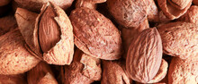Top View Of Almonds Are Unpeeled And Some Peeled For Cover Banner For Social Media Or Other Background Or Wallpaper. Healthy Foods Concept.