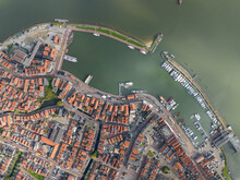 Volendam, Netherlands. Top Down Overview Of Traditional Dutch Fishing Village City Traditional Buildings And Harbor. Touristic Attraction Sky Clouds And Urban City Layout. Aerial Drone View.