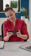 Poster - Vertical video: Financial analyst playing online video games on smartphone, working in startup company. Professional consultant having fun with mobile game on gaming cyberspace, internet play.