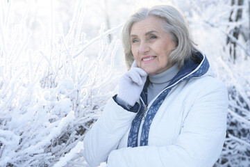 Sticker - Old woman in a fur coat in the winter 