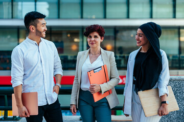 Wall Mural - Diverse coworkers talking outdoors