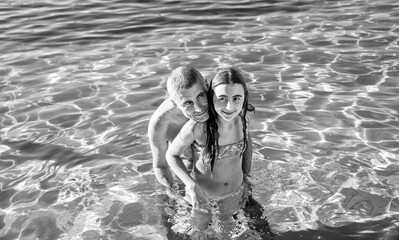 Canvas Print - Father and daughter relaxing on a pool in summer season