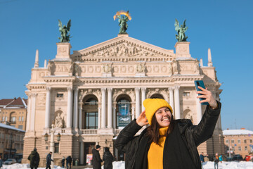 Wall Mural - smiling woman taking selfie in front of opera building