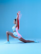 © Georgii - Beautiful white girl in sports uniform makes lunges. Isolated image of sports model on blue background.