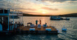 © Caia Image - Carefree couple dancing on houseboat patio on lake at sunset