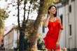 Portrait of beautiful woman smiling and wearing red dress