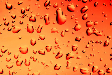 Wall Mural - Water drops background. Wet glass surface texture. Bad autumn weather rainy day. Bubble dew pattern. Transparent window orange raindrops. Bright environment condensation texture.