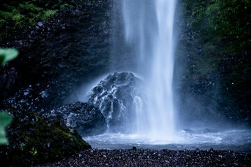 Poster - The bottom of the waterfall splashes the gravel and large boulder.  Then flowing down to create a stream. 