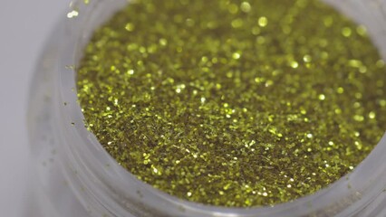 Poster - golden sequins in a jar rotate in a circle